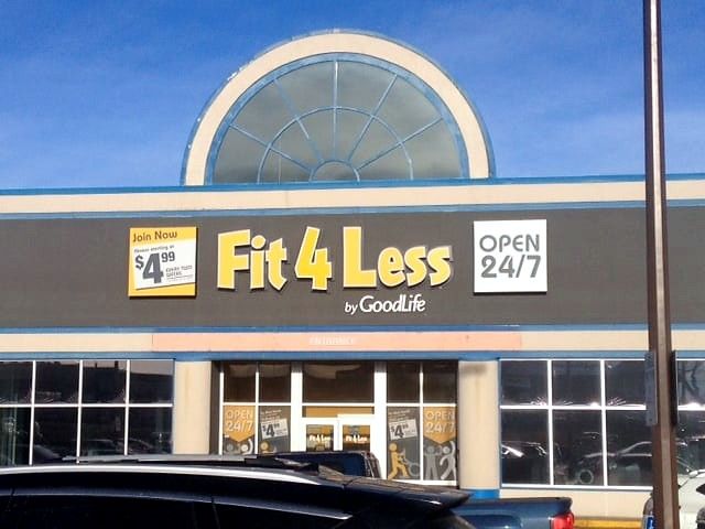 Fit4Less storefront sign and Open 24/7 panel above the gym entrance
