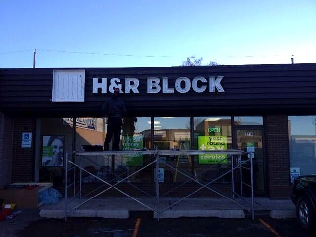 H&R Block storefront with scaffolding during sign installation