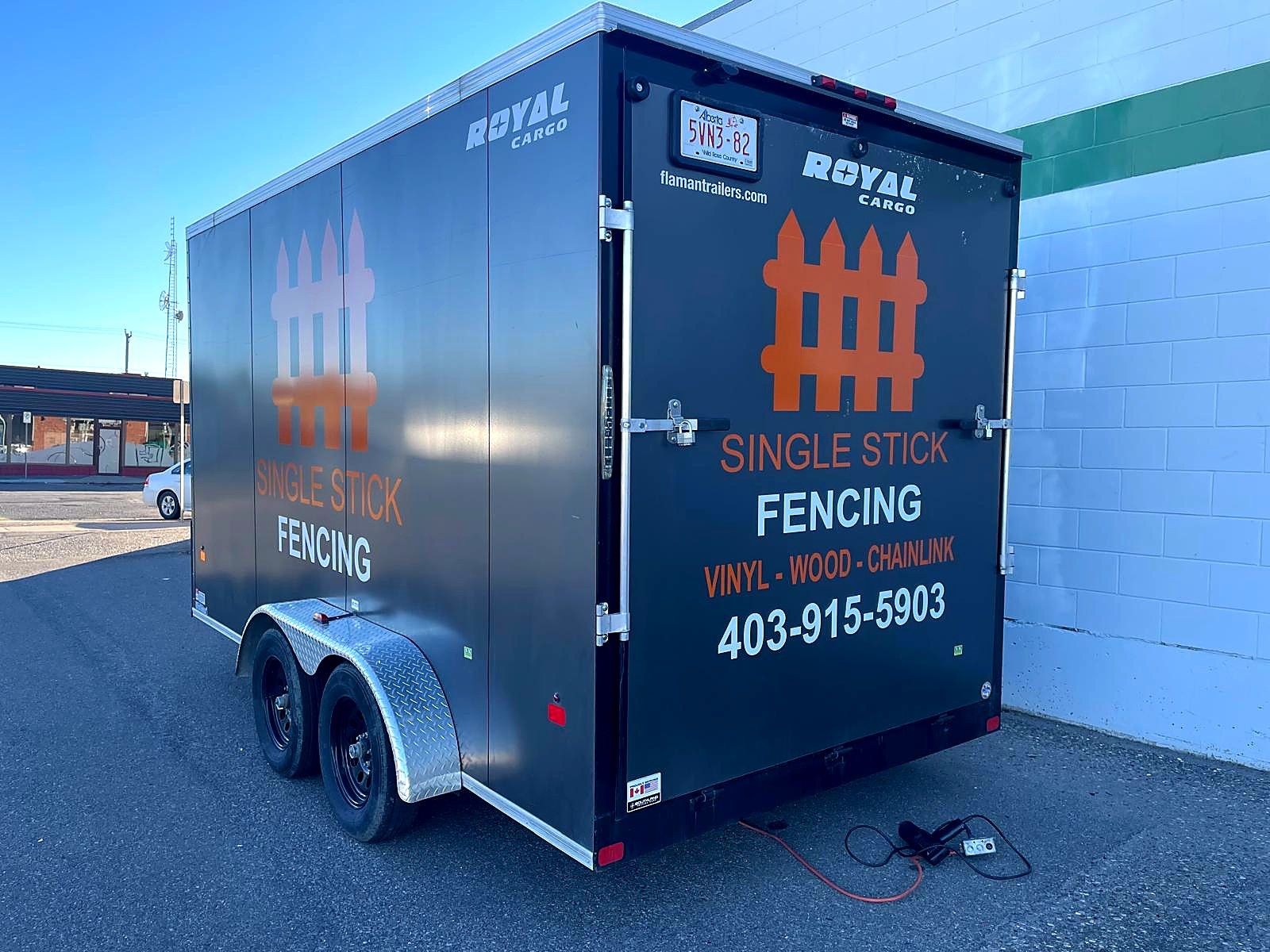 Black cargo trailer with Single Stick Fencing logo, services and phone number