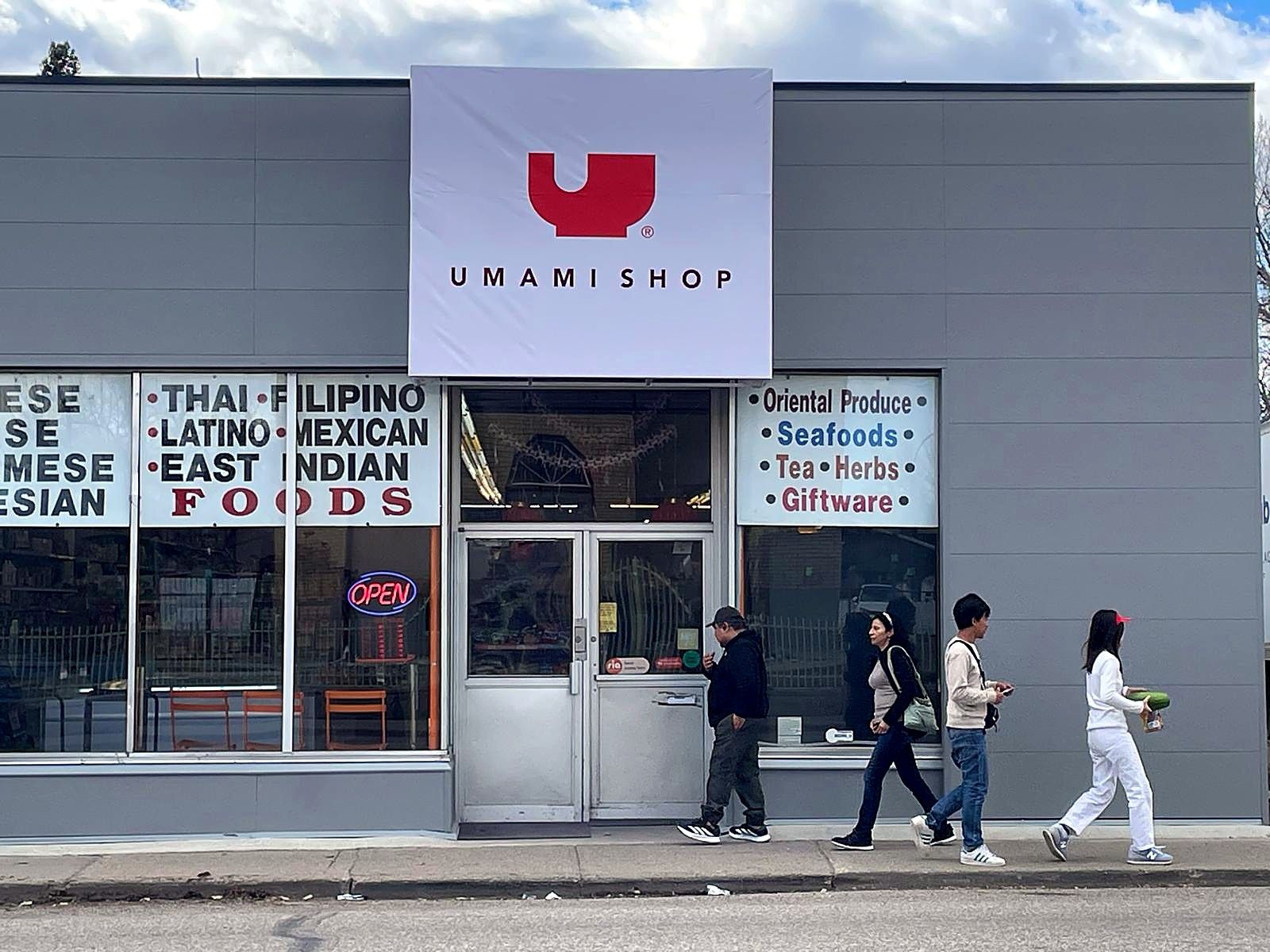 Umami Shop storefront from the street with pedestrians walking past